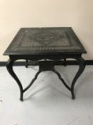 An early twentieth century carved ebonised occasional table