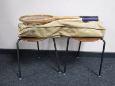 A bag of vintage tennis rackets and two mid 20th century circular stools.