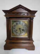 An early 20th century mahogany bracket clock with brass and silvered dial.