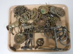 A tray of horse brasses, horse bit, brass horse ornament,
