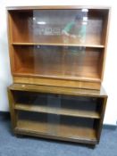 Two sets of mid twentieth century sliding glass door bookshelves