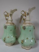 A pair of continental encrusted and gilded ewers