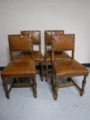 A set of four carved oak buttoned leather dining chairs