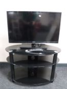 A Toshiba 32 inch lcd tv on stand with remote