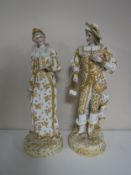 A pair of continental bisque figures of a lady and gentleman in white and gold dress.