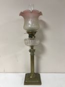 A Victorian glass oil lamp with clear glass reservoir
