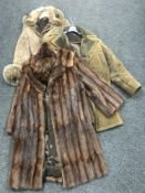 Two sheepskin coats together with a three quarter Coney fur coat