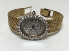 An 18ct gold lady's cocktail wristwatch with diamond set case and dial