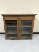 An Edwardian oak glazed door bookcase top