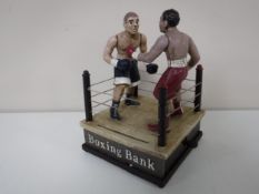 A cast iron money box - boxers. CONDITION REPORT: This is modern.