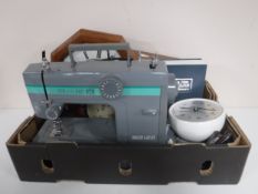 A box of Bizzi Lizzi sewing machine, station style clock,