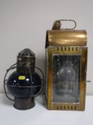 A brass ships lantern together with another ships lamp