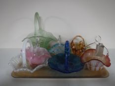 A tray of eight coloured glass baskets