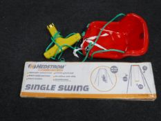 A boxed Hedstrom single swing and a bucket seat
