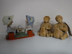 A pair of nodding bisque figures - girl and boy seated with pot, and one other.