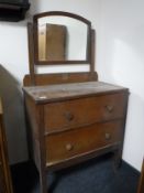 An early twentieth century oak two drawer dressing table