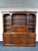 A mahogany Regency style bookcase fitted cupboards and drawers beneath