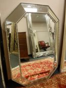 A contemporary panelled cushion mirror,