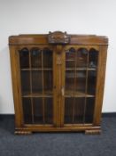 An early twentieth century carved oak display cabinet