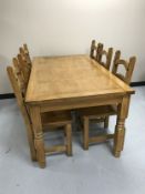 A pine farmhouse style kitchen table and six ladder backed chairs