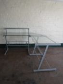 A contemporary metal and glass corner desk