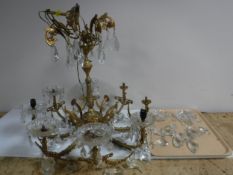 A gilt metal light fitting with glass drops