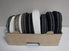 A box of nine spools of Silver Cross pram trim