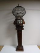 An Eastern style bird cage on carved pedestal