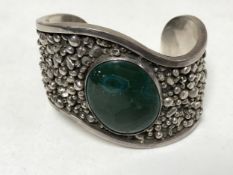 A heavy silver bangle set with malachite, 5.