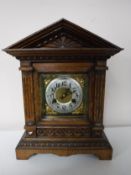 An early twentieth century carved oak cased bracket clock