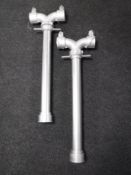 Two metal water hydrant stands.