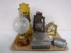 A tray of oil lamp, two paraffin lamps, metal table casket, money box,