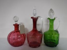 Three antique coloured glass decanters