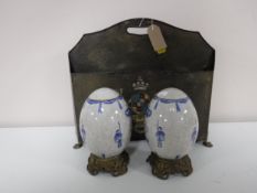 A metal magazine holder with armorial crest,