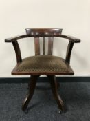 An early twentieth century oak captain's desk chair