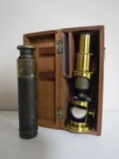 A cased miniature brass microscope together with a pocket brass telescope