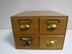 A mid twentieth century oak four drawer index chest
