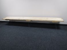 A reclaimed wood 8 foot bench on metal legs