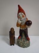 A pottery Gnome figure together with a Swiss wooden nut cracker - Old Lady.