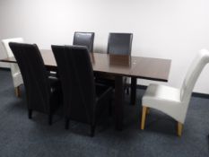 A contemporary pull out dining table together with six high backed leather chairs retailed by