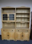 A two section light oak bookcase with drawers and cupboards below
