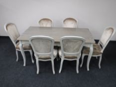 A contemporary French shabby chic dining table with six chairs