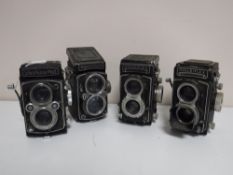A Yashica-Mat Copal-MXV together with three Rolleiflex Franke & Heidecke Synchro Compur cameras