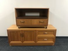 A teak entertainment stand fitted a drawer together with matching low sideboard