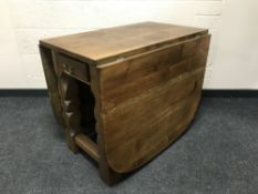 A good quality oak dropleaf dining table, fitted with a drawer, width 89cm.