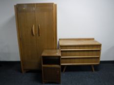 A mid 20th century walnut three piece bedroom suite
