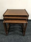 A nest of three 20th century teak tables