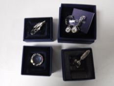 Three boxed Swarovski Crystal miniature ornaments - prism, feather and quill and a doll's pram,