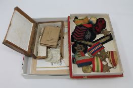 A small collection of medals, military badges, ephemera, etc.