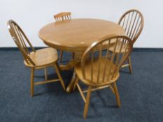 A pedestal kitchen table and four odd chairs